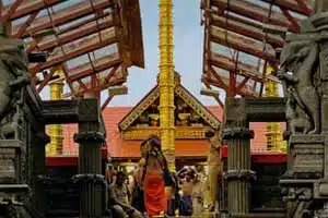 Traditional Sabarimala temple entrance with devotees and temple architecture in Kerala.
