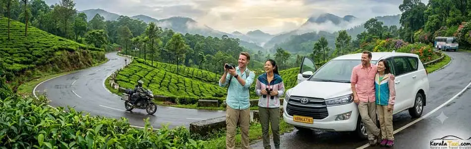 Foreign tourists on a scenic monsoon road trip through the green hills of Kerala.